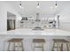 Contemporary kitchen boasting a large island with bar seating, custom lighting and open shelving at 1101 Norris St, Raleigh, NC 27604