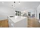 Open floor plan featuring an expansive kitchen island, pendant lighting, and seamless flow to the living area at 1101 Norris St, Raleigh, NC 27604