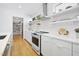 Well-lit kitchen with stainless steel appliances, floating shelves and ample counter space at 1101 Norris St, Raleigh, NC 27604