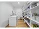 Functional laundry area features a side-by-side washer and dryer, along with ample shelving for organization at 1101 Norris St, Raleigh, NC 27604
