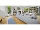 Bright living room with a fireplace, built-in shelving, and large windows overlooking the backyard at 1101 Norris St, Raleigh, NC 27604
