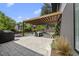Outdoor patio featuring a pergola, stone pavers, grill, and outdoor dining area at 1101 Norris St, Raleigh, NC 27604