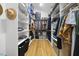 Walk-in closet features wood floor, hat and hanging clothes, and built-in storage at 1101 Norris St, Raleigh, NC 27604