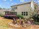 Beautiful backyard featuring a cozy firepit area, lush landscaping, and a screened porch, ideal for relaxation at 1104 Covered Bridge Trl, Chapel Hill, NC 27517