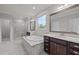 Bright bathroom featuring double vanities, a soaking tub, and a separate glass-enclosed shower at 1104 Covered Bridge Trl, Chapel Hill, NC 27517