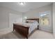 Bright bedroom with a large bed, soft carpet, and two windows providing natural light, creating a peaceful ambiance at 1104 Covered Bridge Trl, Chapel Hill, NC 27517