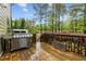 Outdoor deck features a stainless steel grill and overlooks a large backyard with mature trees at 1104 Covered Bridge Trl, Chapel Hill, NC 27517