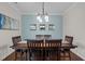 Formal dining room with stylish lighting and ample seating for dinner parties at 1104 Covered Bridge Trl, Chapel Hill, NC 27517