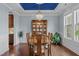 Well-lit dining room featuring a blue ceiling, hardwood floors, and ample natural light at 1104 Covered Bridge Trl, Chapel Hill, NC 27517