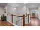 Bright hallway with hardwood floors, white railings, and natural light creating an airy and welcoming atmosphere at 1104 Covered Bridge Trl, Chapel Hill, NC 27517