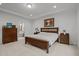 Bright main bedroom featuring a wood bed frame, ensuite bathroom access, and neutral decor at 1104 Covered Bridge Trl, Chapel Hill, NC 27517