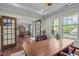 Spacious home office with French doors, hardwood floors, and serene views of the yard at 1104 Covered Bridge Trl, Chapel Hill, NC 27517