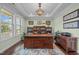Charming office with natural light, hardwood floors, and custom bookshelves at 1104 Covered Bridge Trl, Chapel Hill, NC 27517