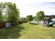 Expansive backyard featuring mature trees, a playhouse, and a playset for outdoor fun at 1209 Redwood Valley Ln, Knightdale, NC 27545