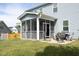 Exterior view of a screened porch with a view of the backyard and patio with fire pit at 1209 Redwood Valley Ln, Knightdale, NC 27545