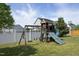 Backyard features a wooden playset with slides, swings, and climbing structure for  at 1209 Redwood Valley Ln, Knightdale, NC 27545