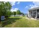 Spacious backyard with lush lawn, a playground, fire pit, and a charming playhouse at 1209 Redwood Valley Ln, Knightdale, NC 27545