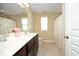 Bathroom features a double sink vanity with a decorative shower curtain and neutral paint at 1209 Redwood Valley Ln, Knightdale, NC 27545