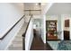 Bright entryway with a staircase, hardwood floors, and stylish decor that offers a glimpse into the home's layout at 1209 Redwood Valley Ln, Knightdale, NC 27545