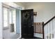 Open front door reveals a glimpse of the porch and the home's interior, highlighting its welcoming ambiance at 1209 Redwood Valley Ln, Knightdale, NC 27545