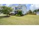 Expansive front lawn view showcasing the home's exterior, vibrant landscaping, and well-maintained surroundings at 1209 Redwood Valley Ln, Knightdale, NC 27545