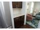 Kitchen area with granite countertops, dark wood cabinets, stainless steel refrigerator, and hardwood floors at 1209 Redwood Valley Ln, Knightdale, NC 27545
