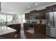 Well-equipped kitchen featuring stainless steel appliances, dark cabinetry, granite countertops, and ample natural light at 1209 Redwood Valley Ln, Knightdale, NC 27545
