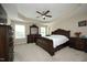 A spacious main bedroom with a decorative ceiling fan, a large bed and dresser, and lots of natural light at 1209 Redwood Valley Ln, Knightdale, NC 27545