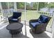 Inviting screened porch featuring wicker furniture with blue cushions and a coffee table at 1209 Redwood Valley Ln, Knightdale, NC 27545