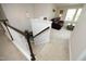 Bright home interior showcasing a staircase leading to a living room with a brown leather sofa and large windows at 1209 Redwood Valley Ln, Knightdale, NC 27545