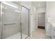 Bathroom with tiled shower, towel rack, and a door to a closet with wire shelving at 1316 London Meadow Way, Fuquay Varina, NC 27526