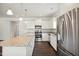 Kitchen featuring stainless steel appliances, granite countertops and a center island at 1316 London Meadow Way, Fuquay Varina, NC 27526