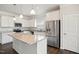 Kitchen with granite counters, a center island, stainless appliances and white cabinetry at 1316 London Meadow Way, Fuquay Varina, NC 27526