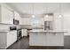 Bright kitchen with white cabinets, granite countertops, and stainless steel appliances at 1316 London Meadow Way, Fuquay Varina, NC 27526