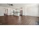 Open concept living space with kitchen island, stainless steel appliances, and hardwood floors at 1316 London Meadow Way, Fuquay Varina, NC 27526