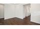 Living room with hardwood flooring, white walls, and entryway to hallway at 1316 London Meadow Way, Fuquay Varina, NC 27526