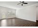 Spacious living room with wood floors, fan, and a door leading to the outside at 1316 London Meadow Way, Fuquay Varina, NC 27526