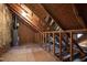 View of attic with unfinished rafters and gas water heater in an unfinished space at 1412 Amberton Ct, Raleigh, NC 27615
