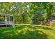 View of grassy backyard with wooded area at 1412 Amberton Ct, Raleigh, NC 27615