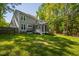 Rear exterior of home with screened in porch and wooded area at 1412 Amberton Ct, Raleigh, NC 27615
