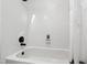Bright bathroom bathtub with white tile, black fixtures, and shower curtain at 1412 Amberton Ct, Raleigh, NC 27615