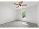 Bright bedroom featuring gray carpet, ceiling fan and a window with natural light at 1412 Amberton Ct, Raleigh, NC 27615