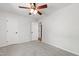 Bright bedroom featuring neutral carpet, a ceiling fan, and two closets with doors at 1412 Amberton Ct, Raleigh, NC 27615
