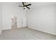 Spacious bedroom with gray carpet, ceiling fan and attached bathroom and closet at 1412 Amberton Ct, Raleigh, NC 27615