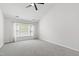 Large bedroom with gray carpet, ceiling fan, and a window with privacy blinds at 1412 Amberton Ct, Raleigh, NC 27615