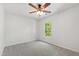 Bright bedroom featuring gray carpet, ceiling fan and a window with natural light at 1412 Amberton Ct, Raleigh, NC 27615