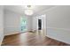 Open dining area with hardwood floors, white wainscoting, and a view to the front door at 1412 Amberton Ct, Raleigh, NC 27615