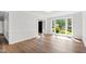Bright, neutral room with gorgeous wood floors and natural light from a large window at 1412 Amberton Ct, Raleigh, NC 27615