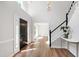 Inviting home entryway with hardwood floors, a staircase, and a contemporary chandelier at 1412 Amberton Ct, Raleigh, NC 27615