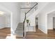 Bright foyer with hardwood floors, staircase, and modern chandelier creates a welcoming entrance at 1412 Amberton Ct, Raleigh, NC 27615
